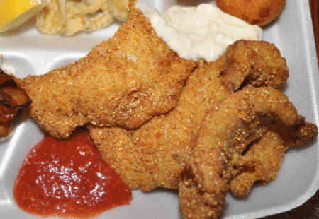 Recipe: Kicked-Up Deep-Fried Crappie Crispy fried fish fillets served with tartar sauce and ketchup on white plate
