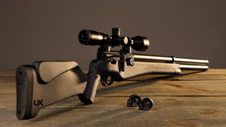 Best Full-Auto Air Guns of 2024 Umarex UX air rifle with scope and pellets on wooden surface