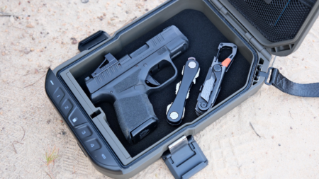 The Best Gun Safe Deals Right Now—Up to 46% Off Black compact pistol and multi-tool stored in foam-lined portable lockbox case.