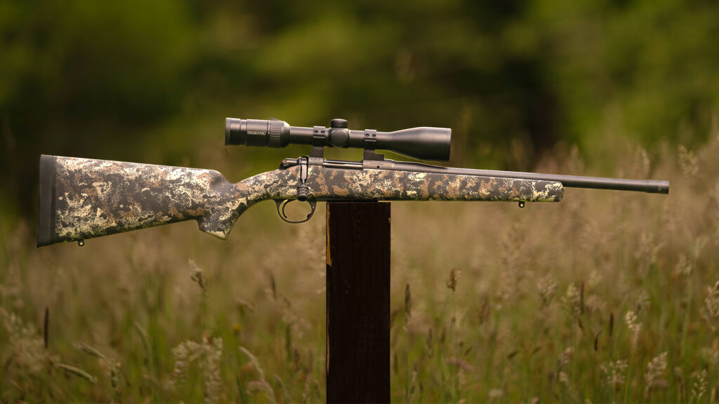 Wilson Compbat NULA 20S rifle balanced on a post in a field.