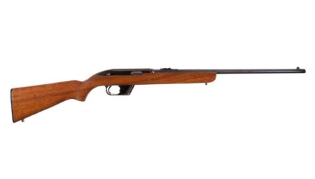 Vintage semi-automatic rifle with wood stock and blued steel barrel on white background