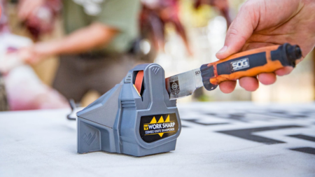 The 6 Best Knife Sharpeners Hand sharpening an SOG knife using a Work Sharp Combo Knife Sharpener outdoors.