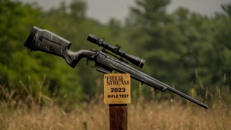 Bolt-action rifle with scope on Field & Stream 2023 Rifle Test post outdoors