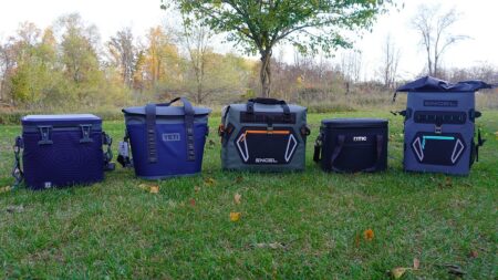 The Best Soft Coolers of 2025, Tested and Reviewed Five soft-sided cooler bags from brands including Yeti, Engel, and RTIC on grass.