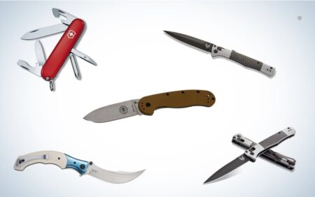 Five folding knives including Swiss Army knife and Benchmade tactical blades on white background