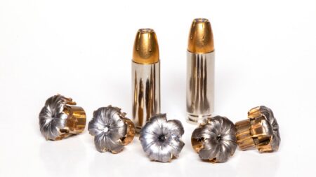 Two unfired hollow point bullets alongside five expanded mushroomed bullets after impact.