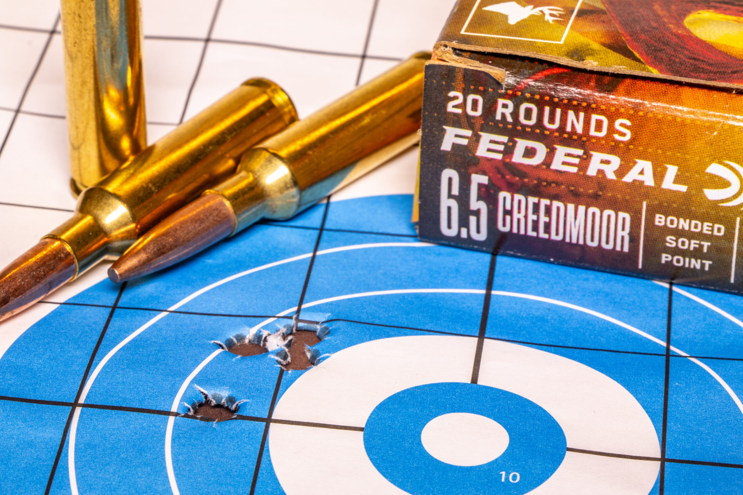 A group of bullet holes in a rifle target with Federal 6.5 Creedmoor ammo. 