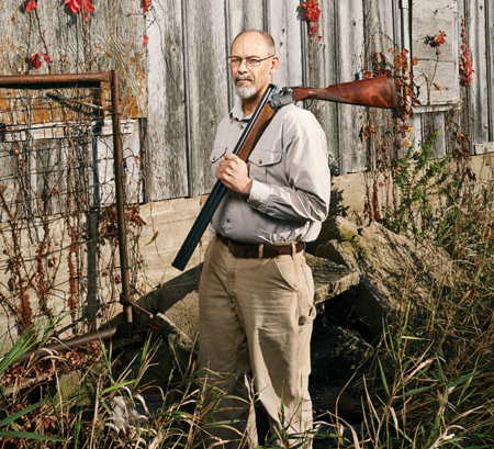 F&S Classic: Dad’s Gun Middle-aged man holding a shotgun over his shoulder near a rustic barn