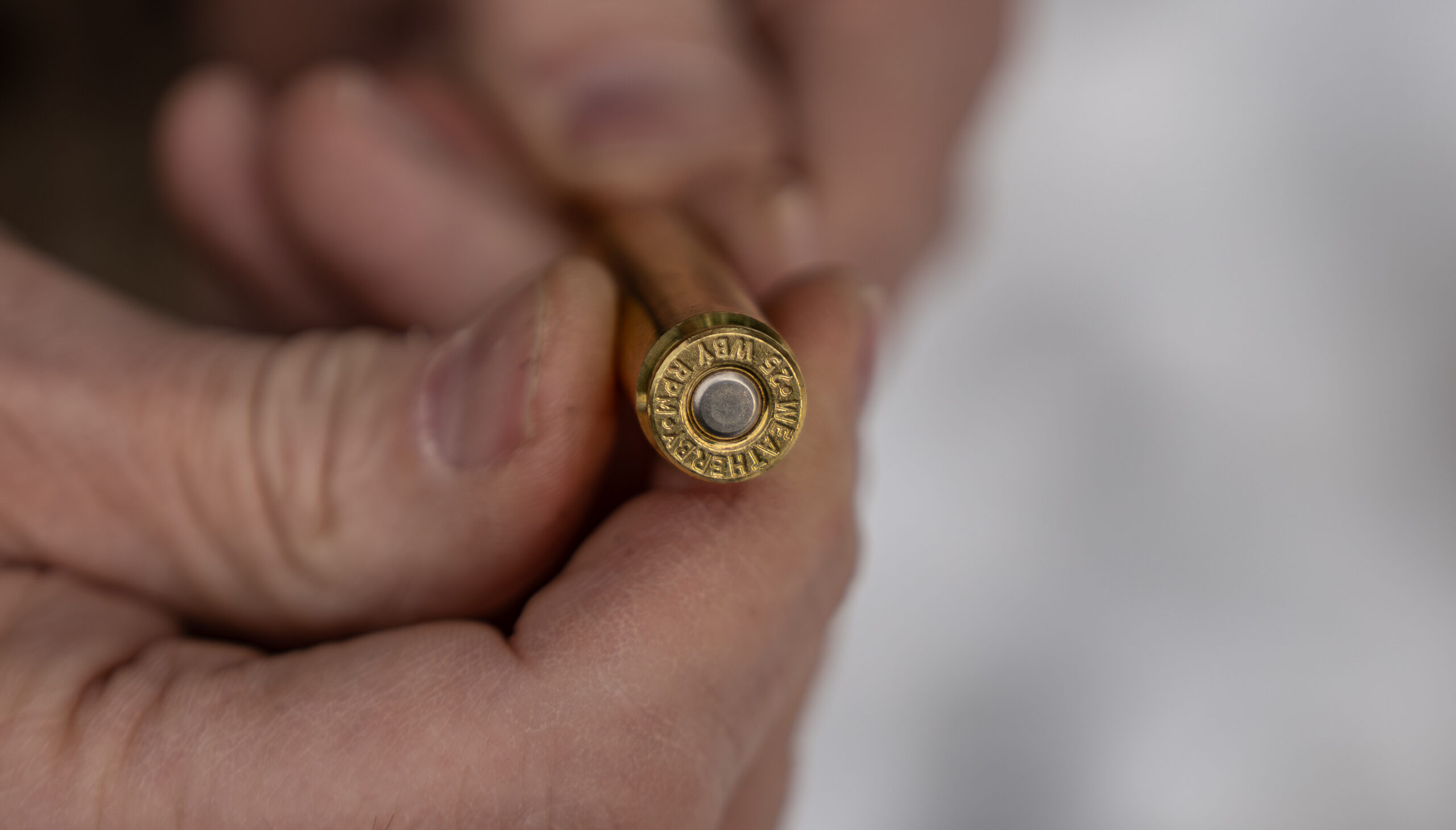 Field & Stream's shooting editor examines the rim of a new Weatherby cartridge. 