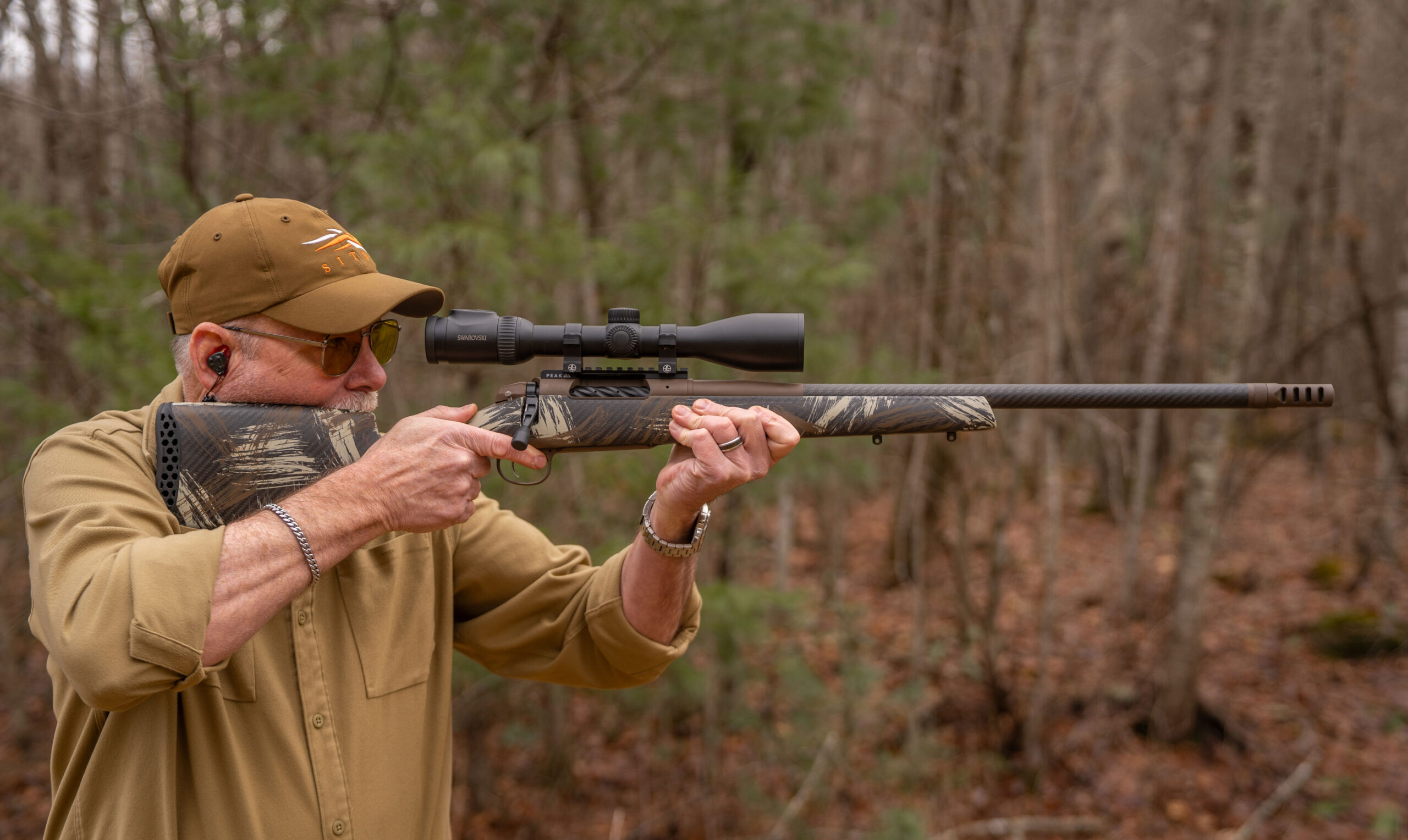 A marksman aims a hunting rifle.