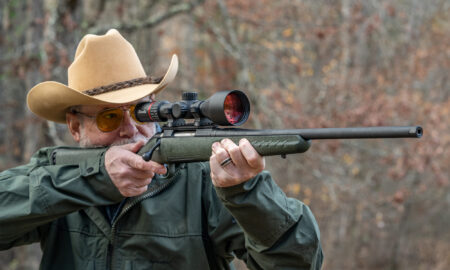 The Best Budget Rifles of 2026, Tested and Reviewed A man shoots a Glenfield Model A rifle in the woods.