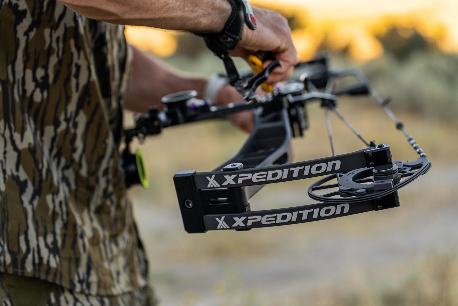A bowhunter holds the new Xpedition NexLite compound bow.
