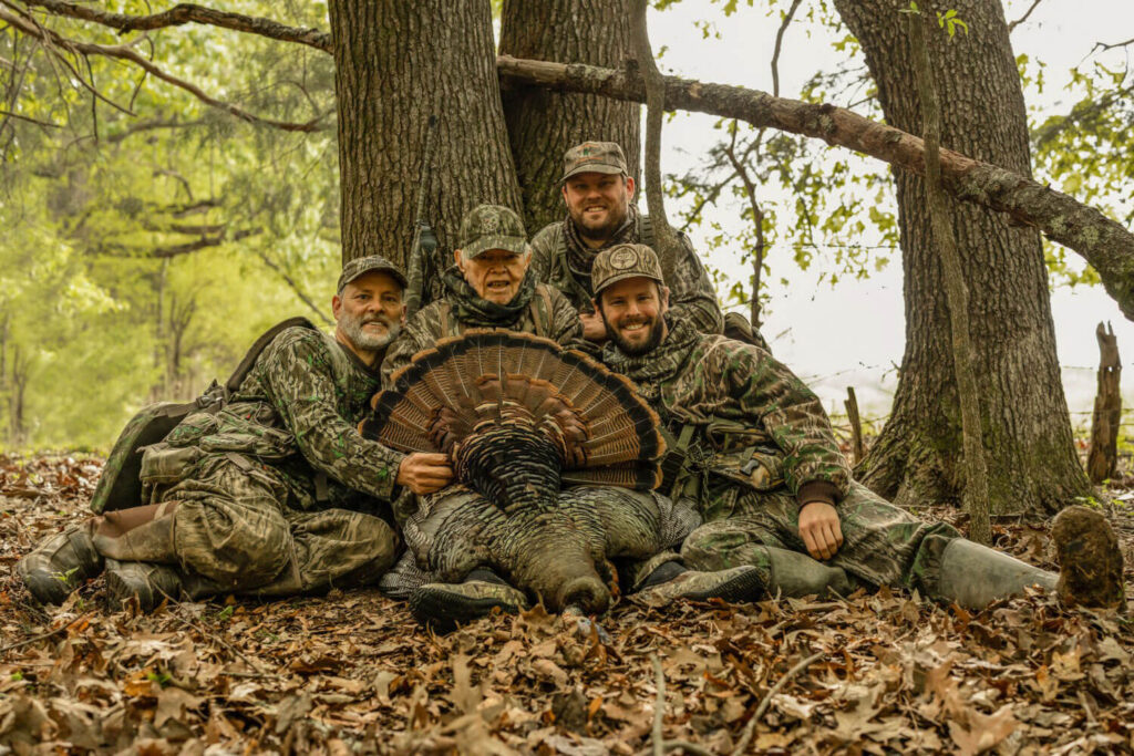 A group of turkey hunters pose for a photo after a successful hunt.