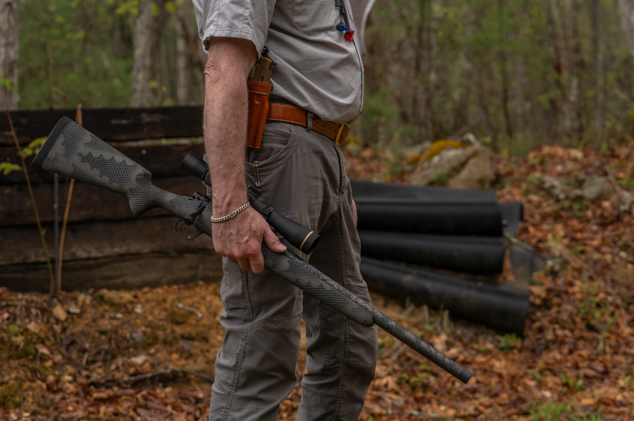 A shooter holds the Proof Glacier Ti rifle by his side. 