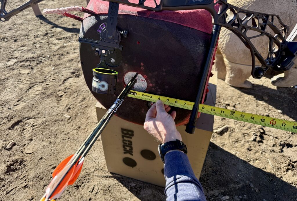 A person measure a tight group of arrows shot with the new Mathews ARC 30 compound bow. 