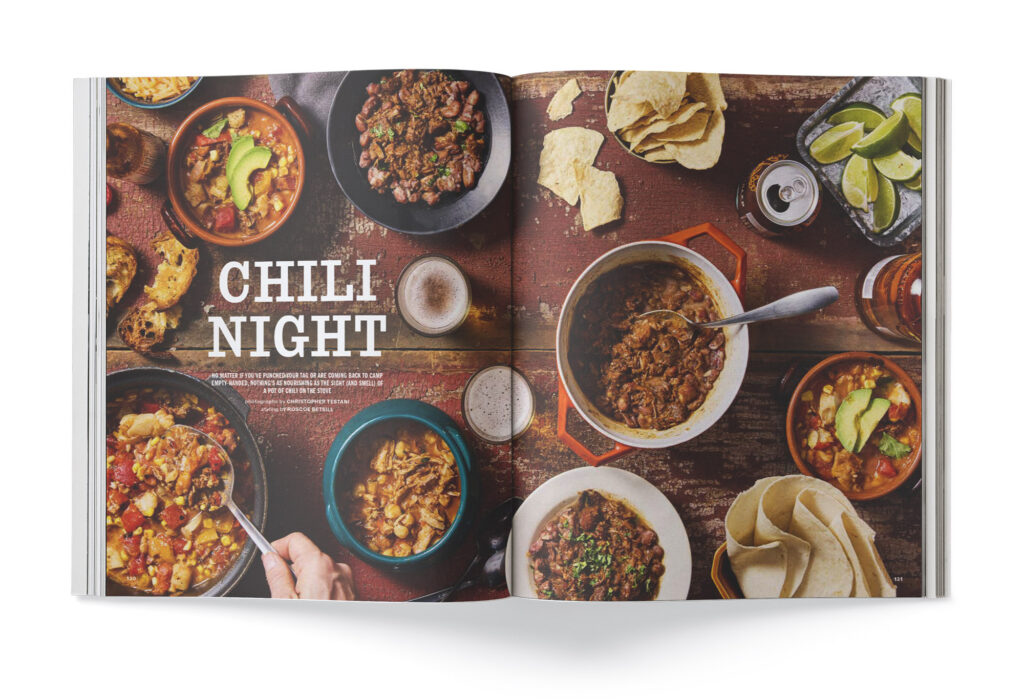A magazine spread with a collection of chili recipes on a table.