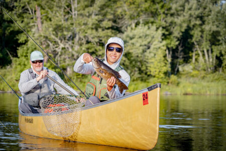 Bill Would Allow Banned Mining Activities Upstream of Famed Boundary Waters Wilderness Area An angler poses with a smallmouth bass caught in the Boundary Waters Canoe Area Wilderness.