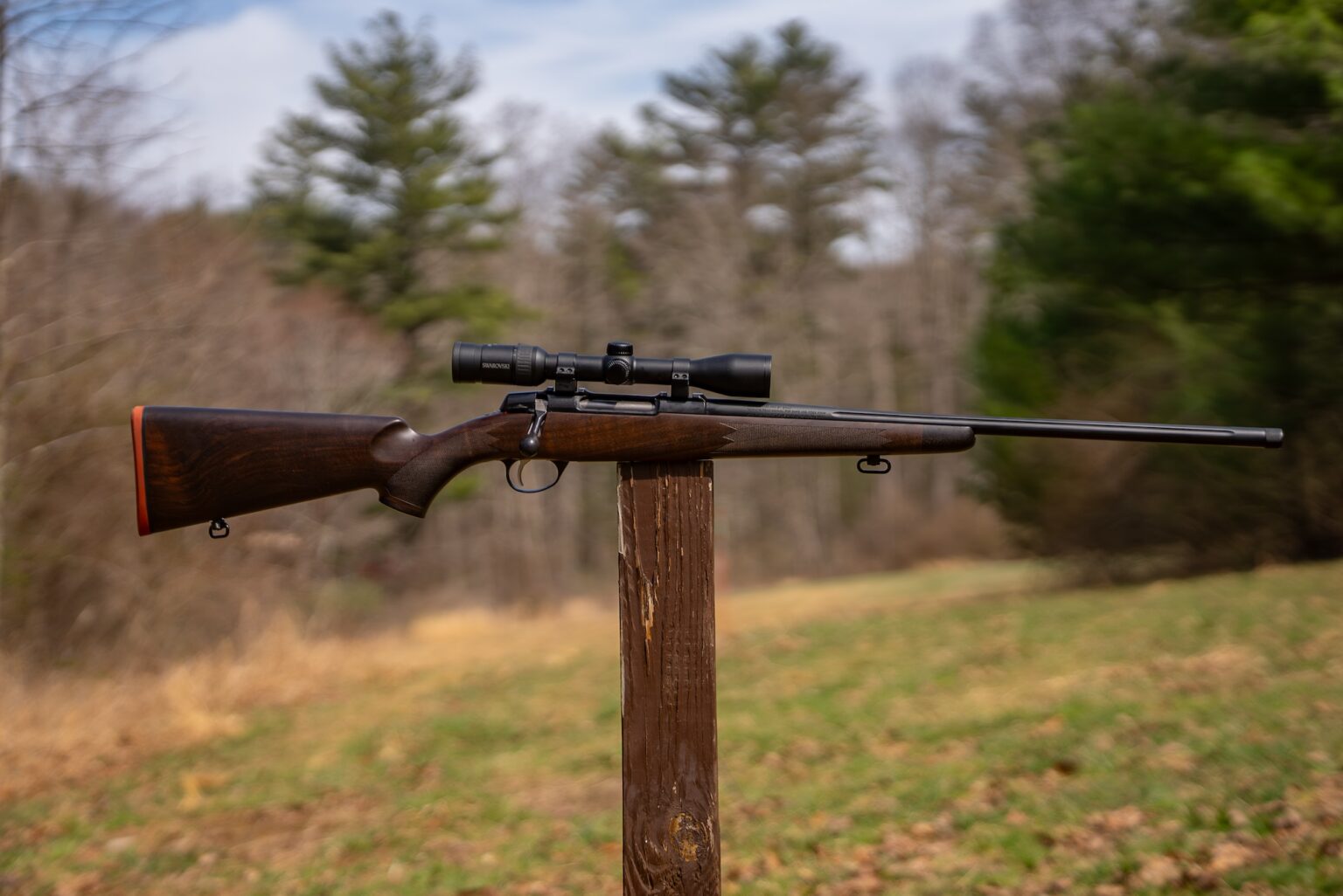The new Sako Grizzly rifle on a post in a field.