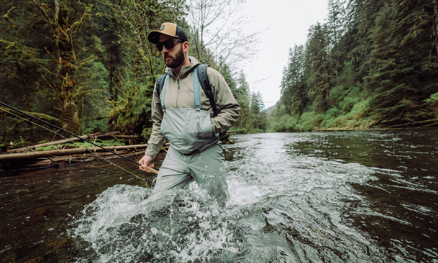 Fly fisherman wearing Sitka CrossCurrent Fishing Waders in river