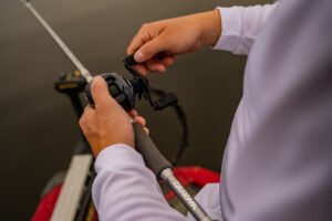 Angler reeling in a bait with a baitcasting reel