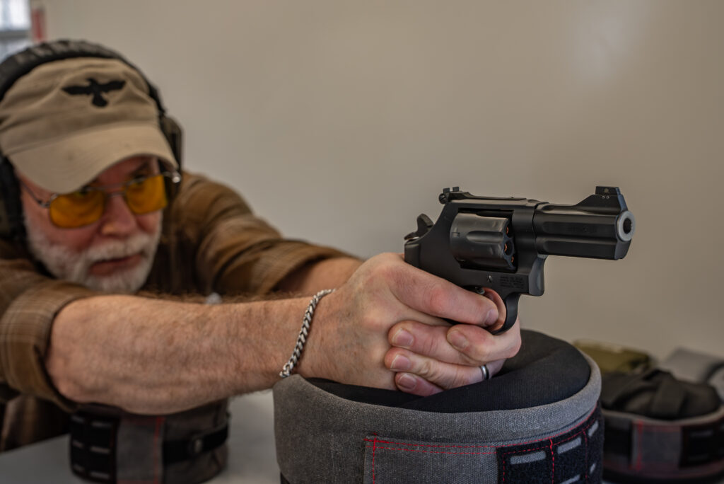 A man fires the new Lipsey's S&W Model 386 NightGuard handgun.