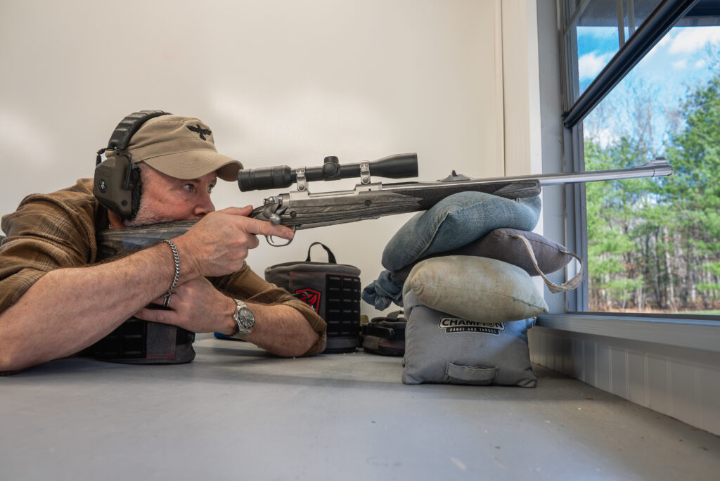 A shooter fires Lipsey's Ruger Alaskan Bush Rifle from a bench rest. 
