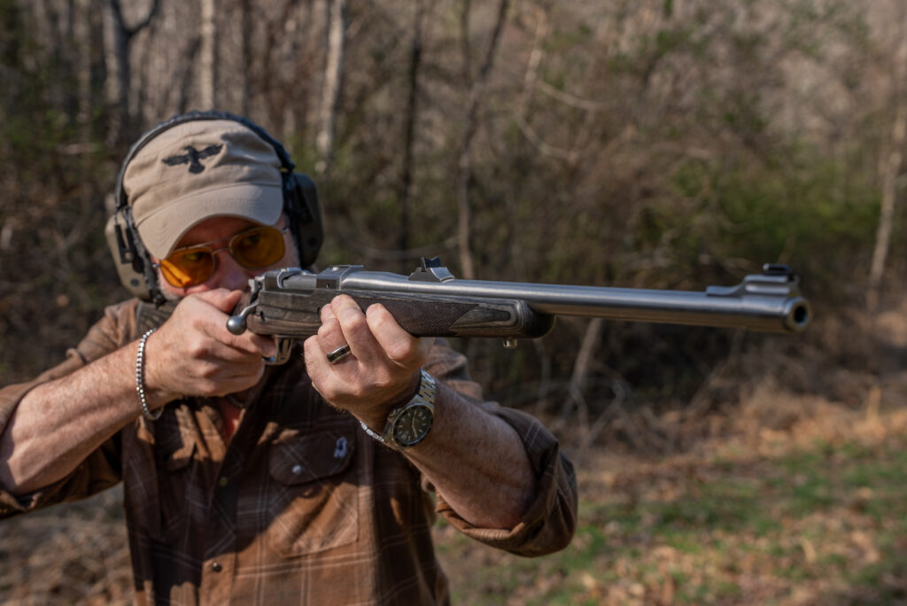 A shooter fires the Alaskan Bush Rifle from off-hand. 