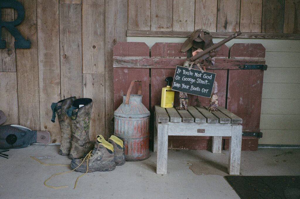 Boots and a chair outside of a hunting camp
