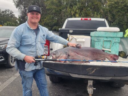 A Florida angler poses with a record-breaking blue catfish.