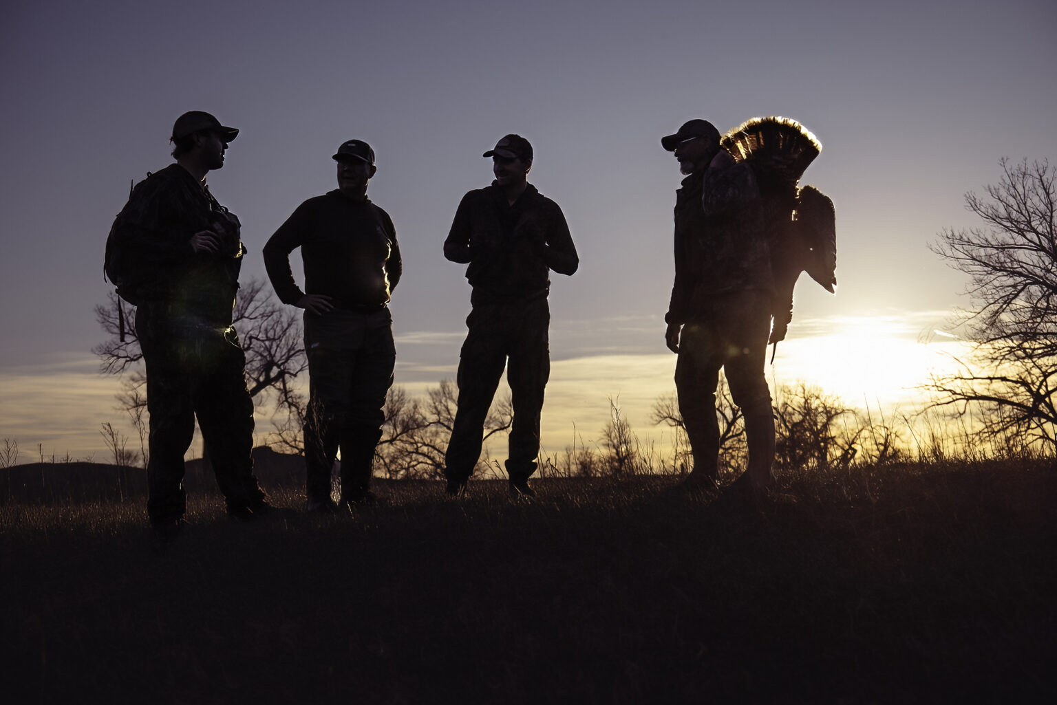 Hunters stand around after a successful hunt