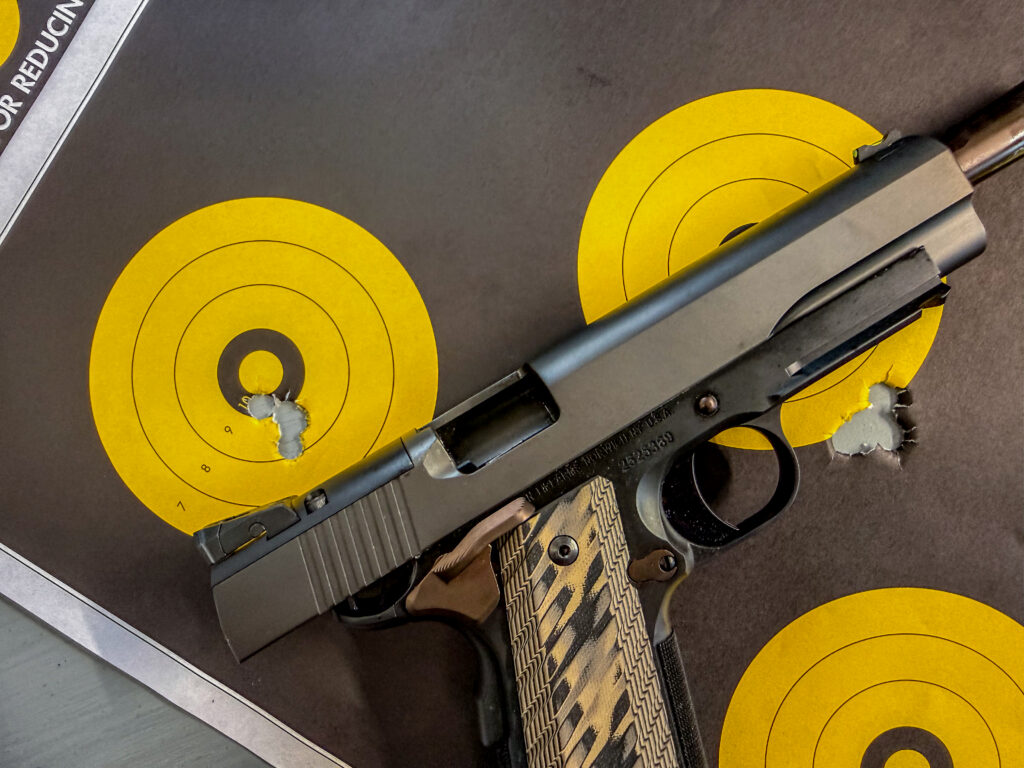 The Dan Wesson Kodiak 1911 on a target with bullet holes.