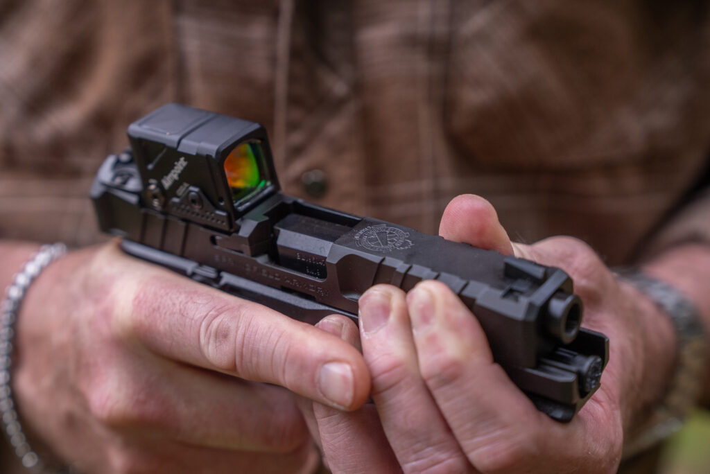 A man manipulates the slide of the new Springfield-Armory Echelon. 