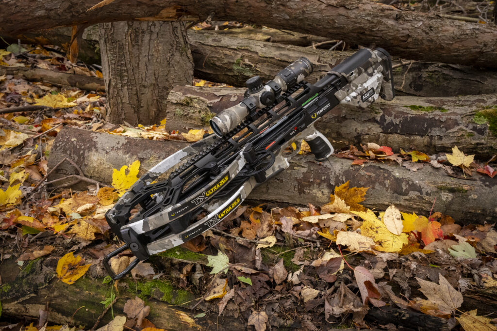 TenPoint TX Ultra 29.5 crossbow on logs and leaves