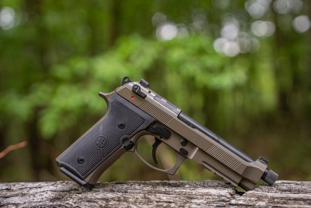 Beretta M9A4 Overlanding Nomad Bronze resting on a board