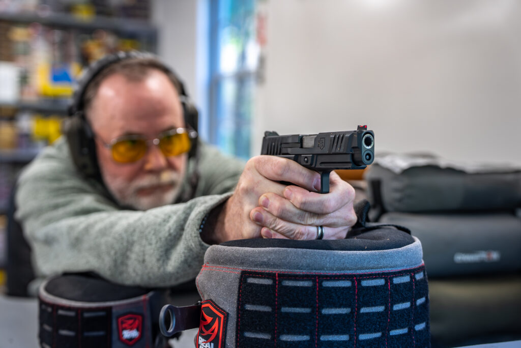 A man shoots the new Wilson Combat Bulwark from a rest.