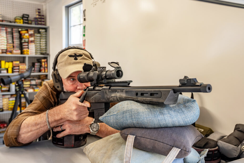 A man shoots the new Franchi MULE from a rest in a shooting house. 