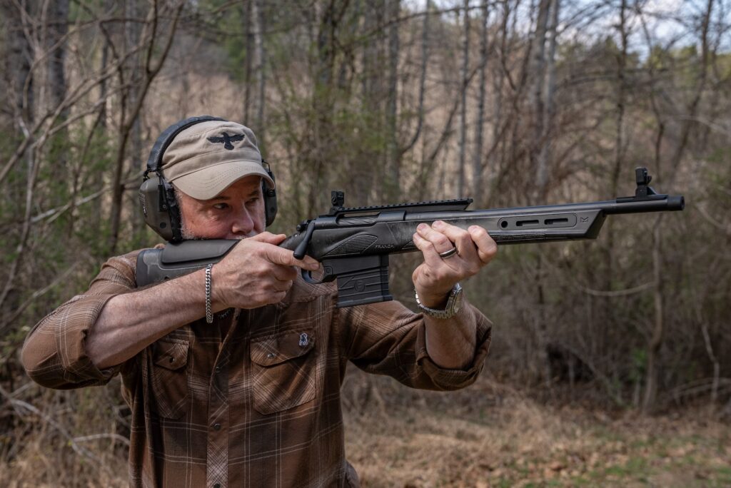 A man shoots the new Franchi MULE rifle in a field. 