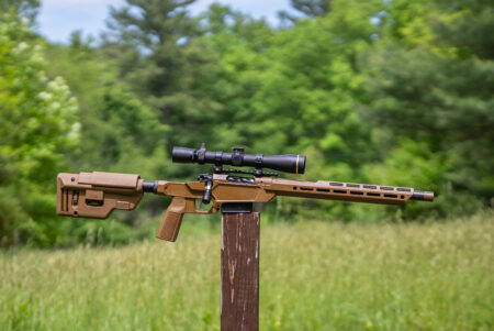 Springfield-Armory Heatseeker rifle balanced on a post in a field