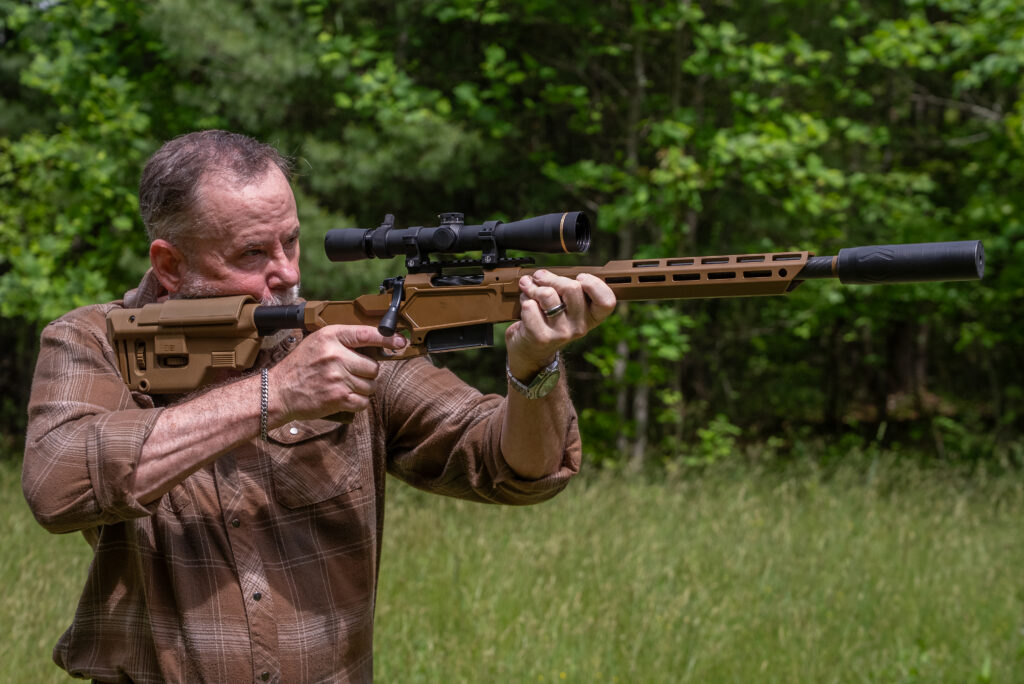 A man shoots the Springfield Armory Heatseeker rifle in a field