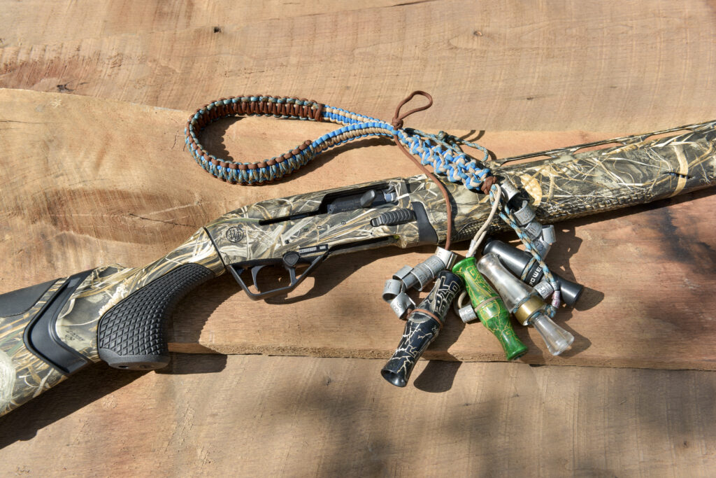 The Beretta A400 Solo next to a duck call lanyard 