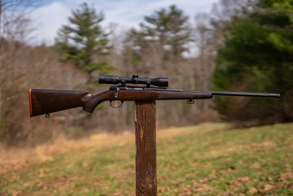 Sako Grizzly rifle balanced on a post in a field