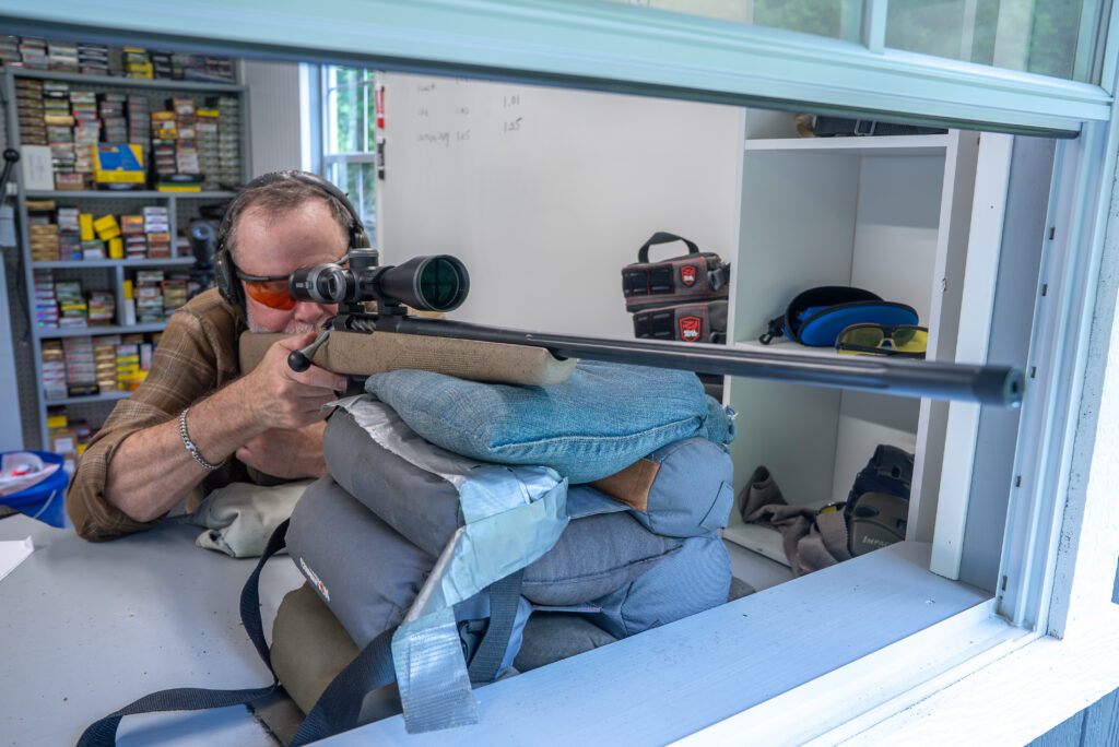 A shooter fires the Tikka Roughtech rifle from a shooting house.