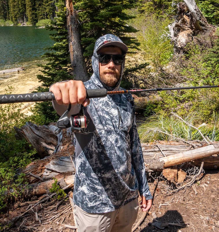 Angler holding up Ugly Stik GX2 travel rod kit
