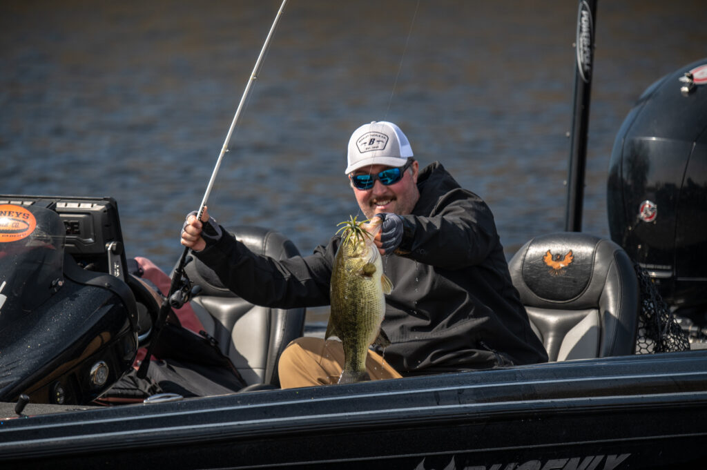 Angler holds up a bass hooked with an urchin bait 
