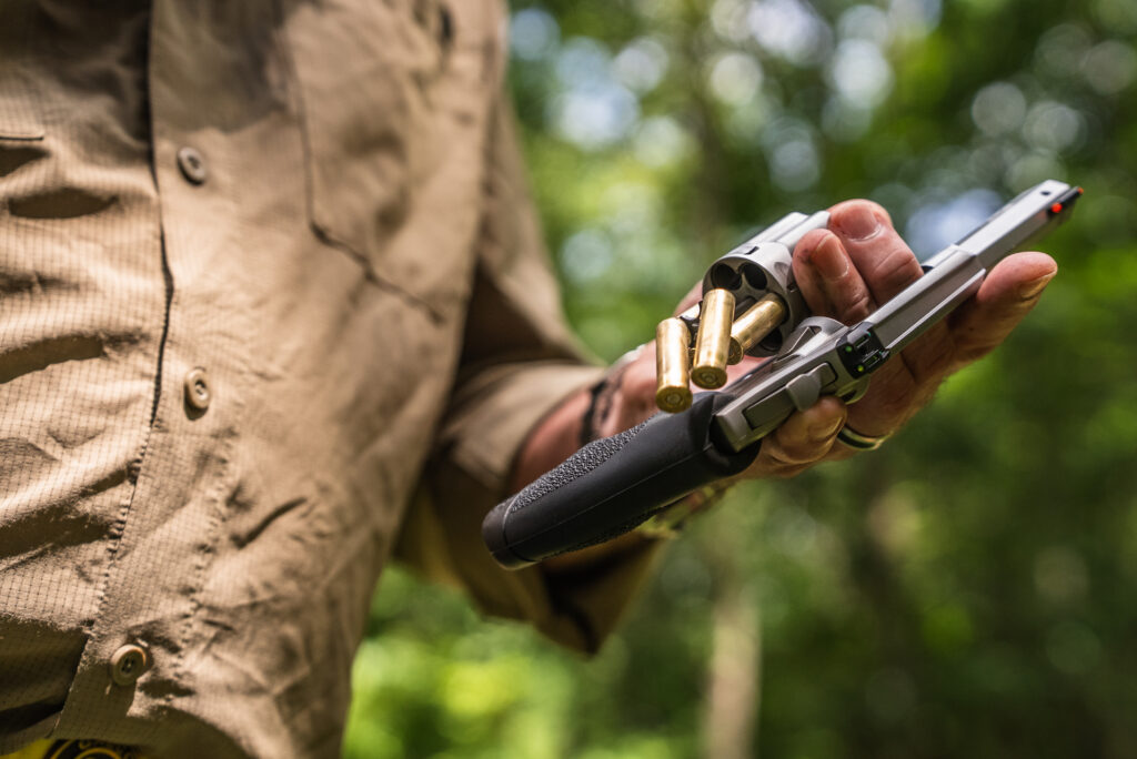 A man removes empty cases from the Diamondback SDR revolver. 
