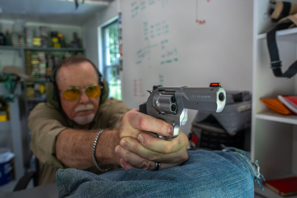 A shooter fires the Diamondback revolver from a bench rest. 