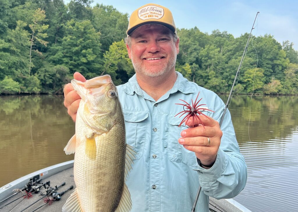 Angler holding up largemouth bass and Hag's Prickly pear urchin bait