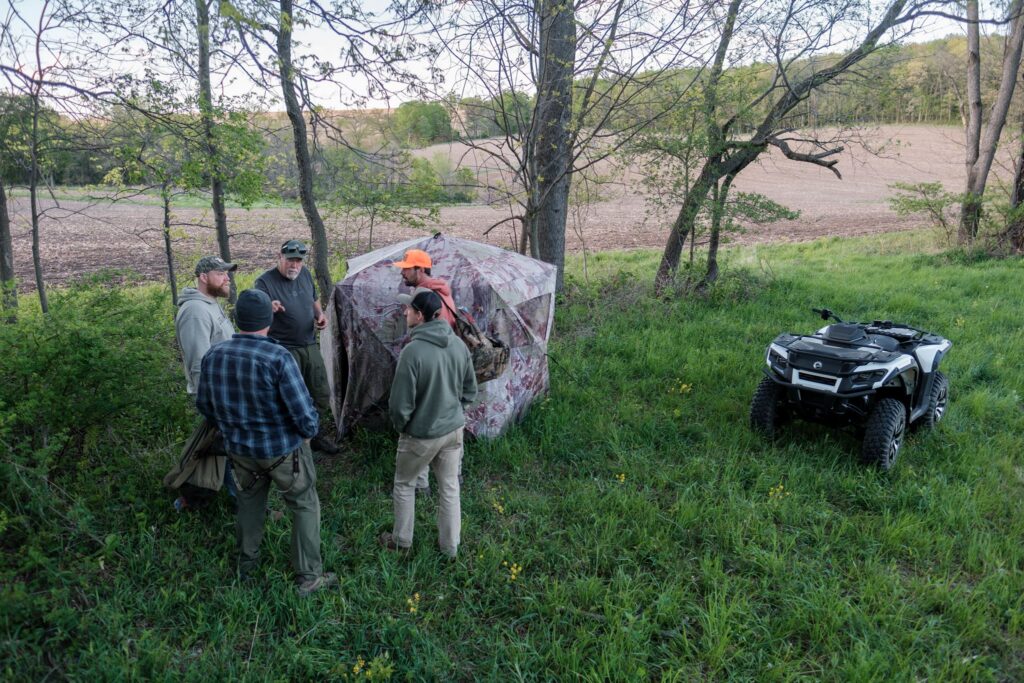 Hunters discuss land management practices before a turkey hunt.