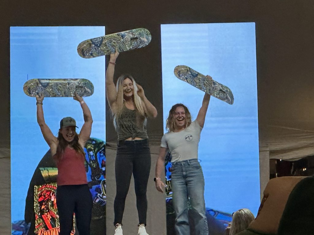 A stand-up paddleboarder stands atop the podium after winning a race in Tennessee. 