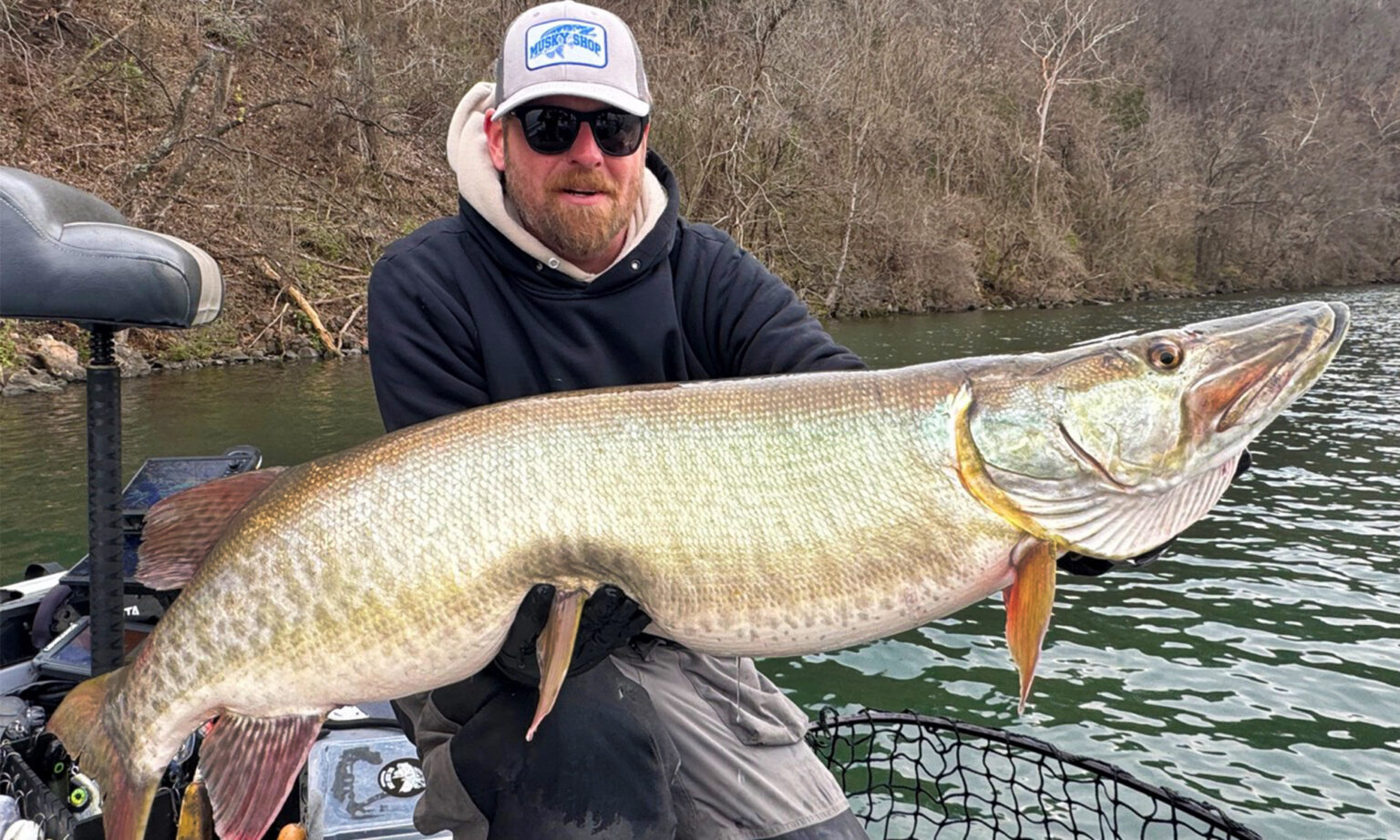 How to Fish Live Bait for Muskies—Responsibly A fisherman holds up a huge musky.
